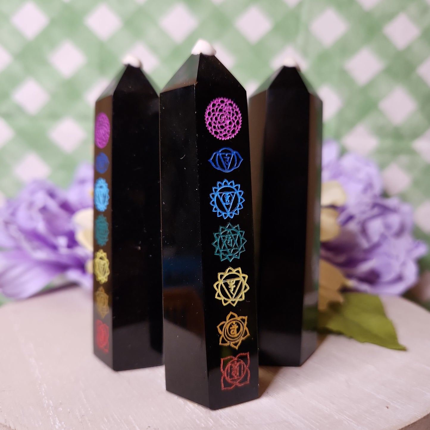 Black obsidian tower with painted chakra symbols