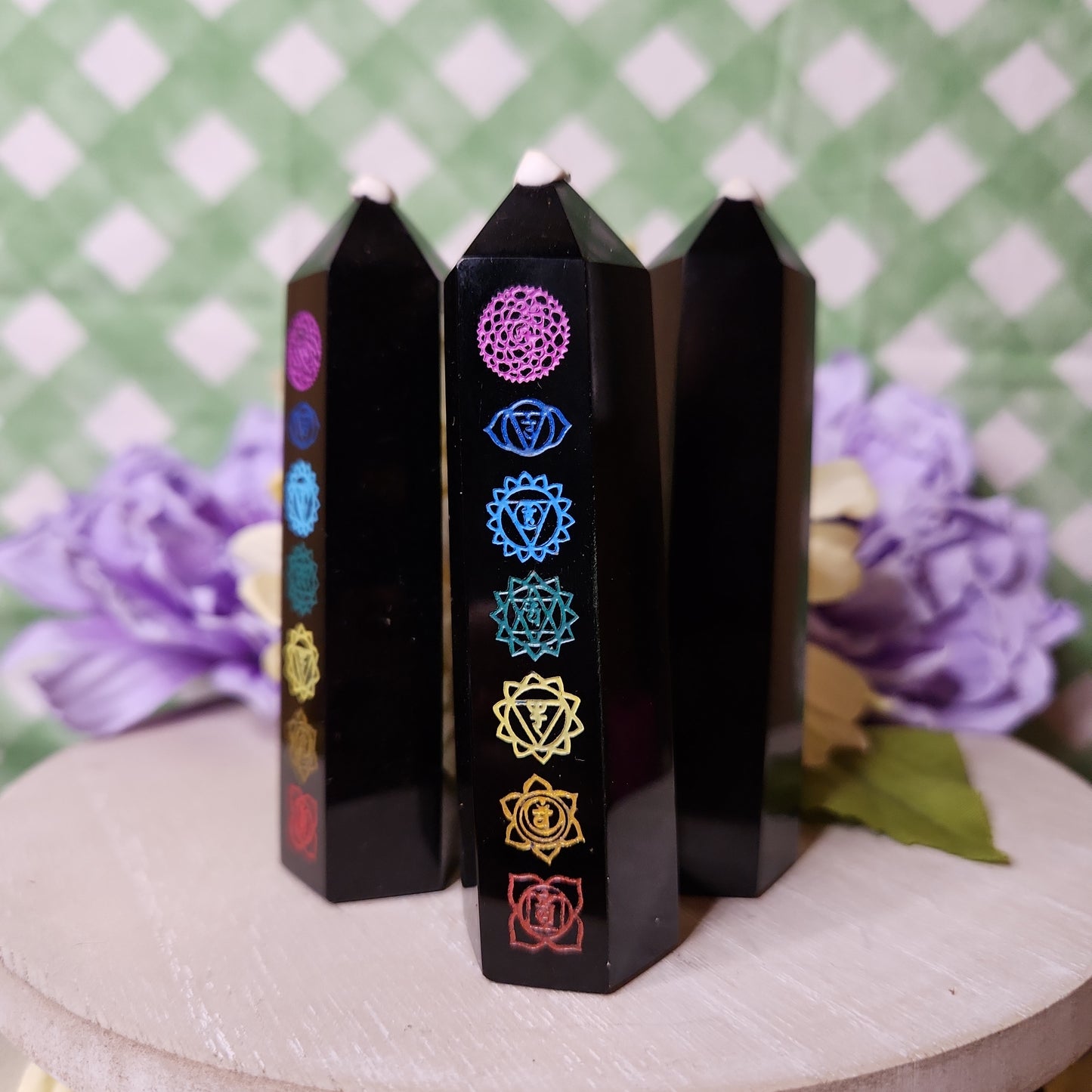 Black obsidian tower with painted chakra symbols
